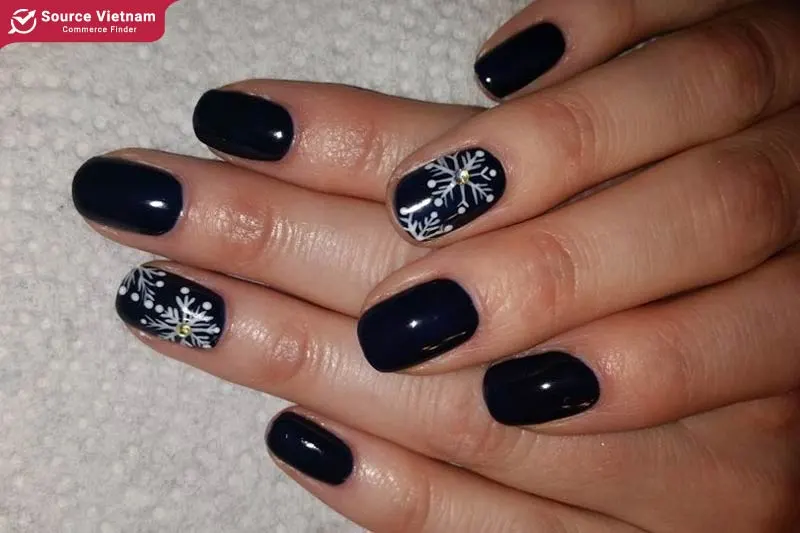 Basic black nail with snowflake design